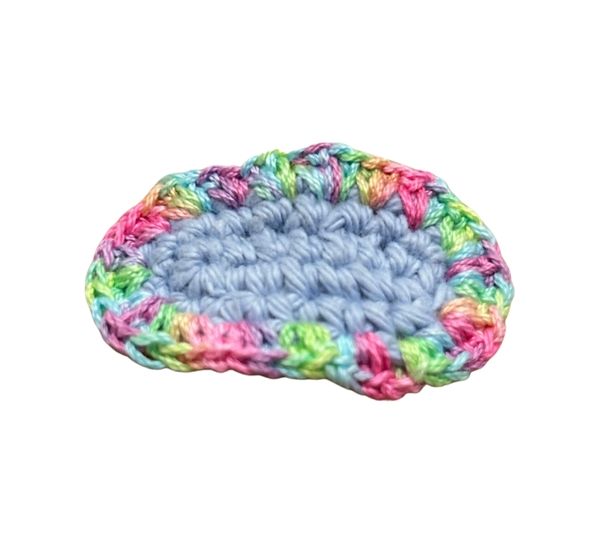 Handmade crochet hair clip with soft blue center and multicolor ruffled edge – Rainbow Ruffle accessory for baby and toddler girls