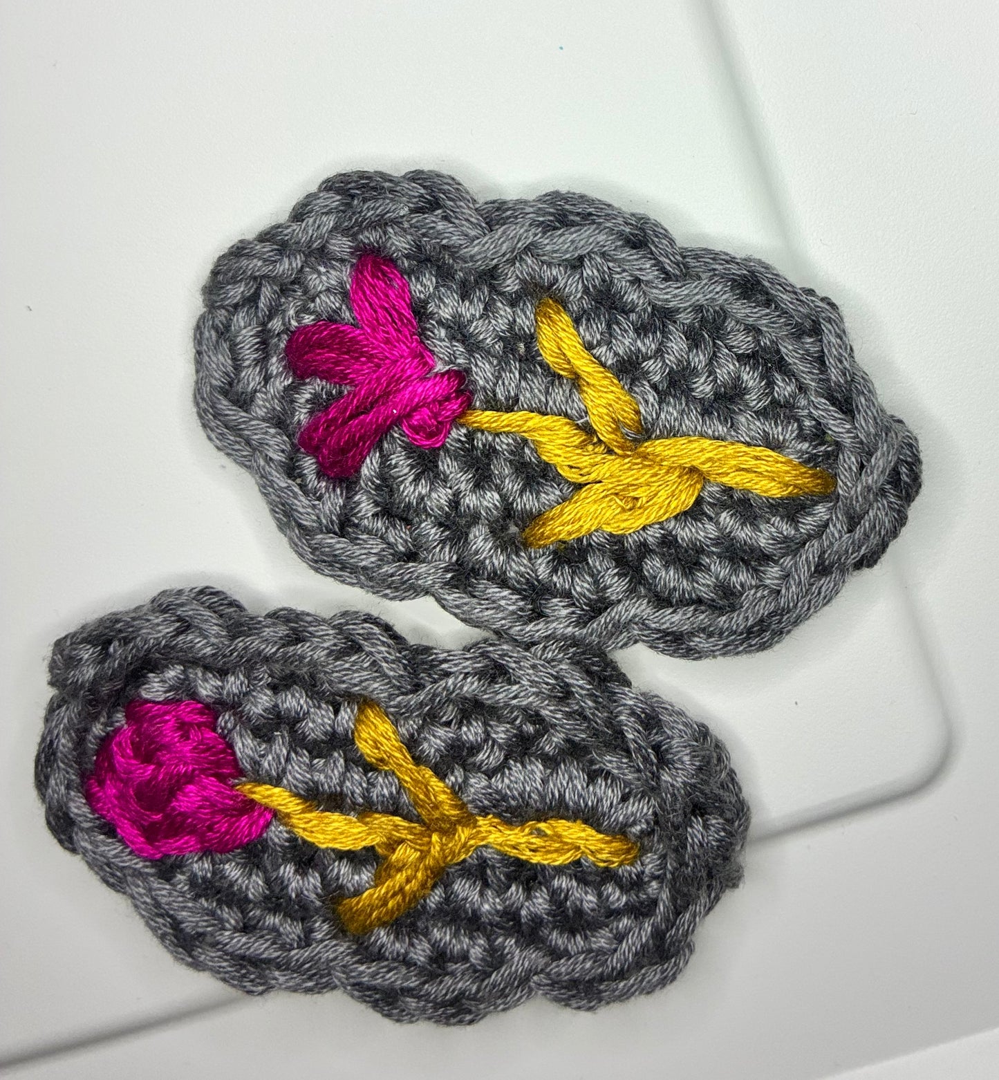 Storm Petal embroidered crochet hair barrettes featuring vivid floral stitching on a dark base – artisan clip for baby girls