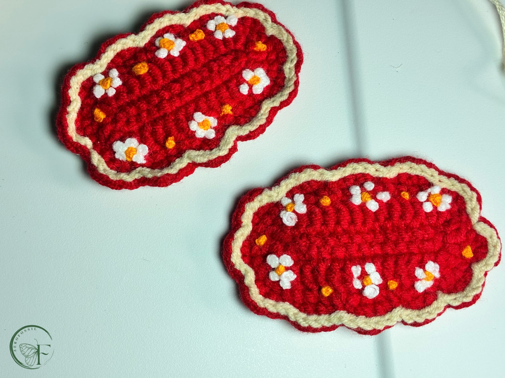 Scalloped-edge red yarn hair accessories with daisy-like embroidered flowers – eco-friendly toddler clips